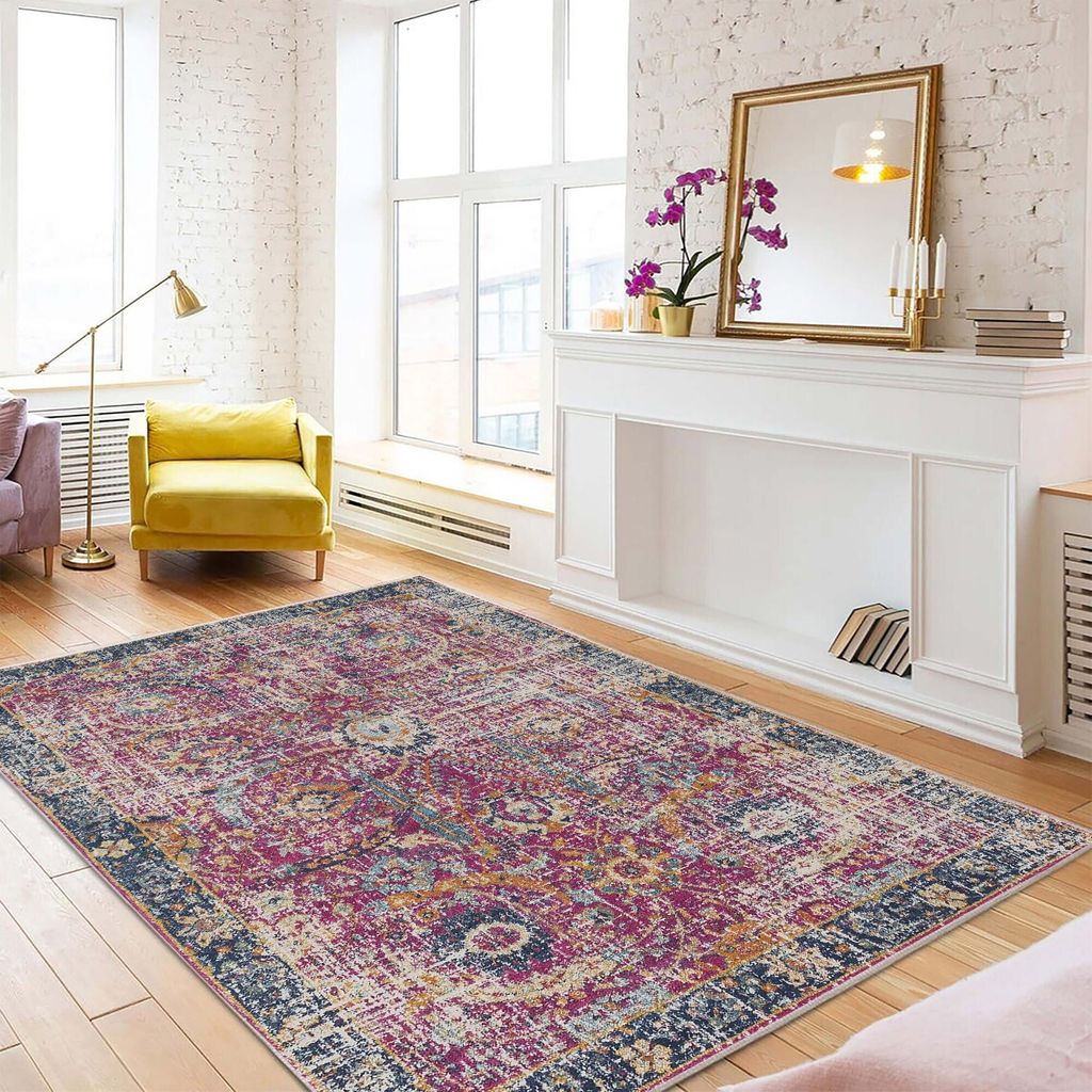 A living room scene with a rug, fireplace, and furniture.