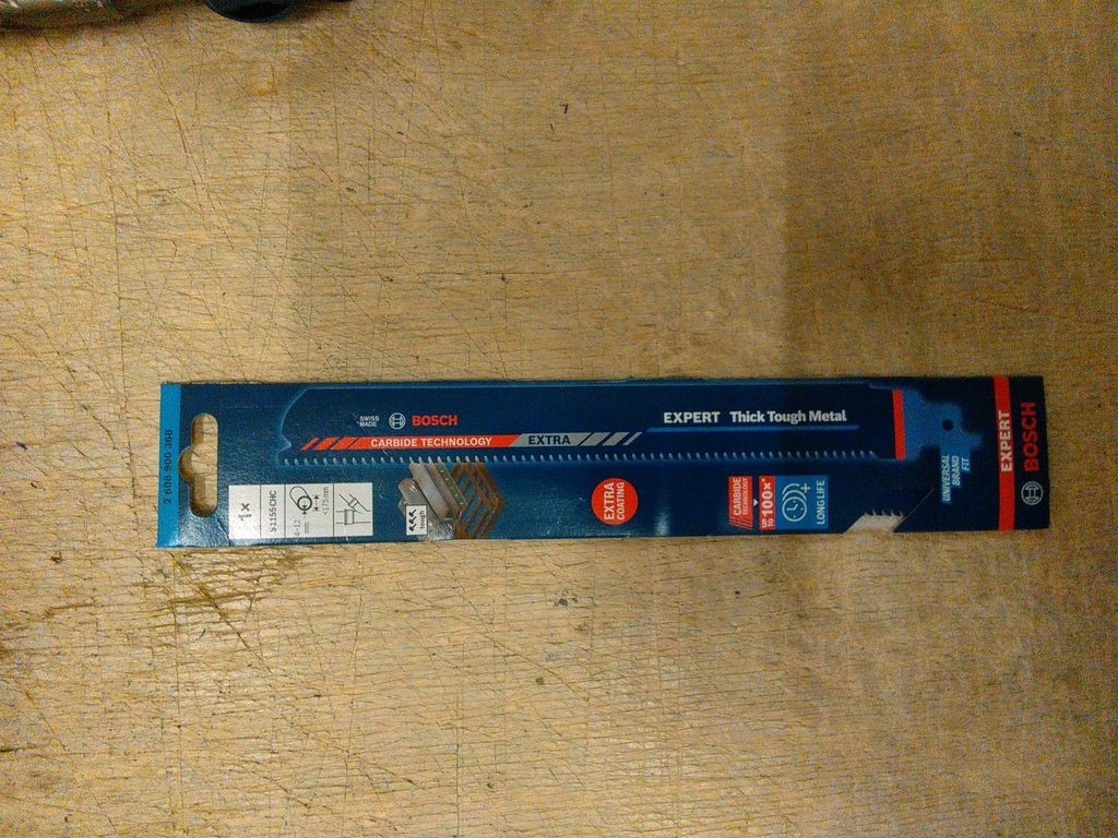 A Bosch EXPERT saw blade in its packaging, lying on a wooden surface.