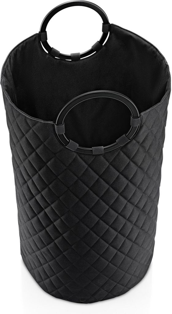 A black quilted laundry basket with round handles.