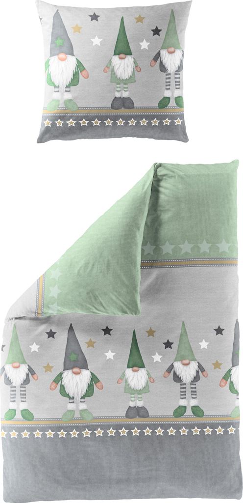 A pillow and a folded duvet cover with a gnome and star pattern.