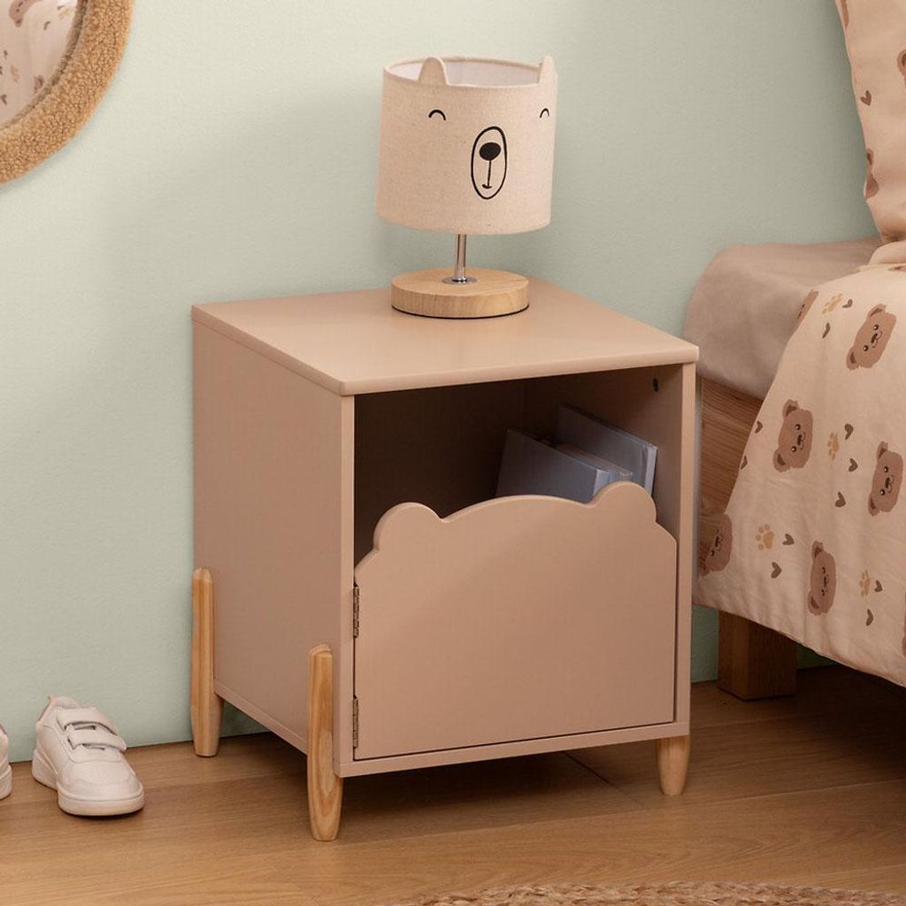 A child's bedroom with a bedside table and lamp.