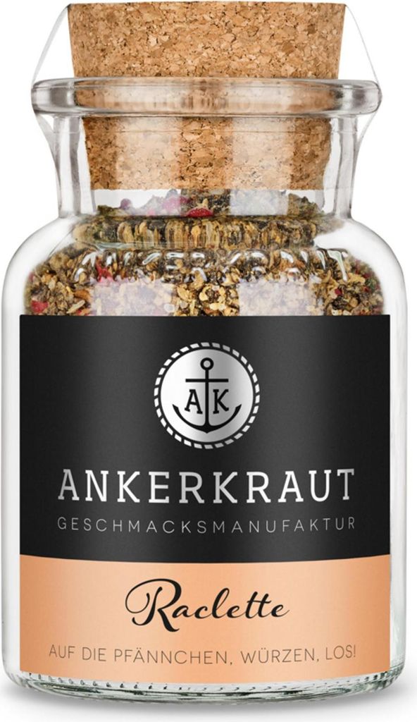 A glass jar of spice blend with a cork stopper, on a white background.