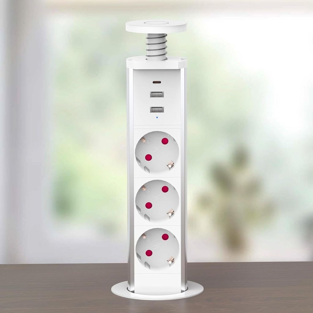 A white retractable power strip with USB ports is shown on a wooden surface in front of a blurred window.
