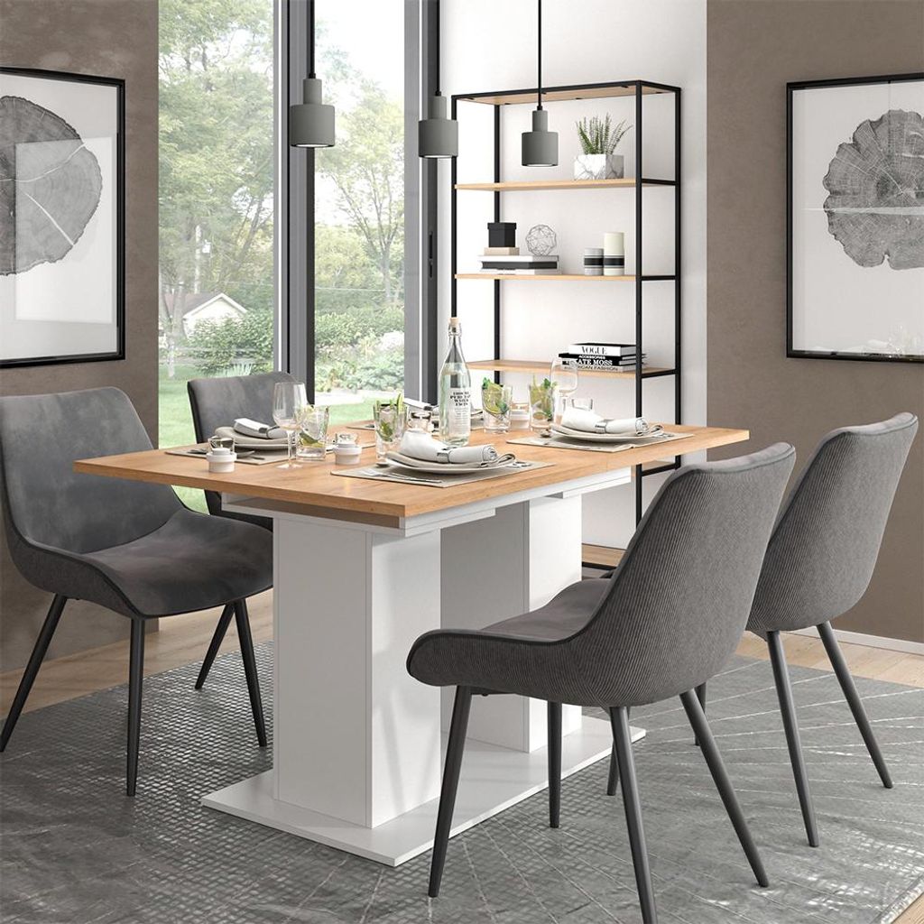 A dining table and chairs set in a well-lit room with a large window and a bookshelf.