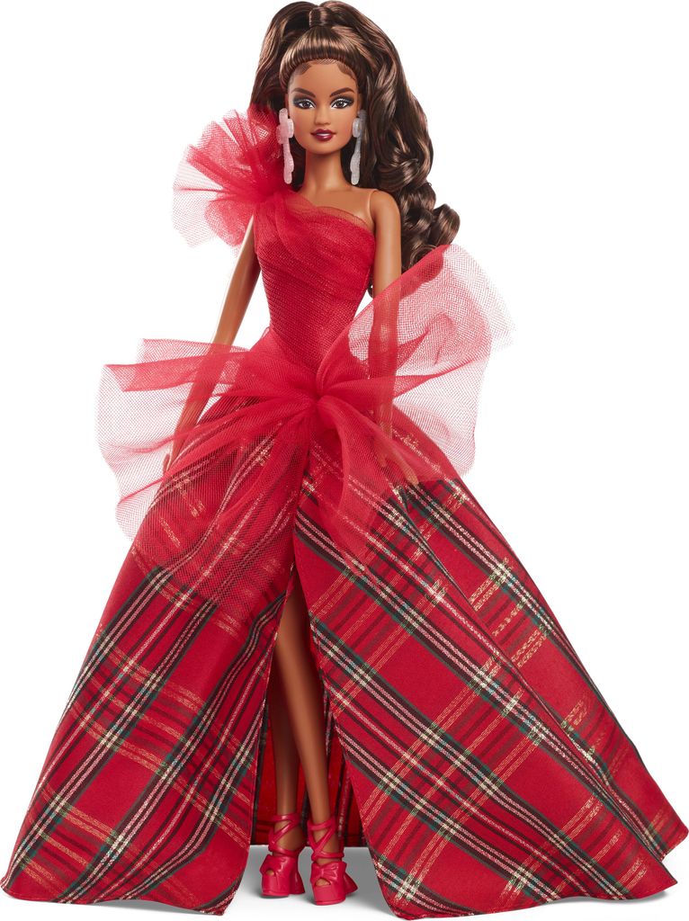 A Barbie doll wearing a red plaid gown.