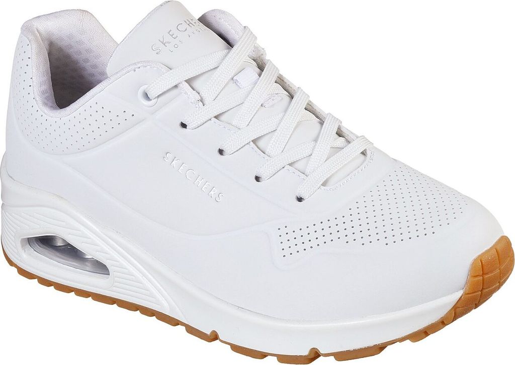 A white Skechers sneaker with a brown sole is shown from the side.