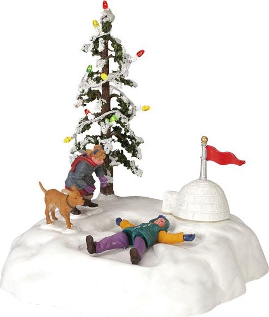 A miniature Christmas village scene with a decorated tree, an igloo, and figures playing in the snow.