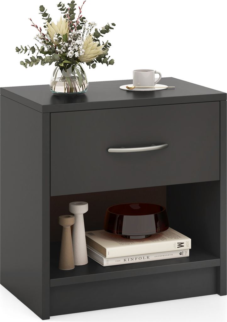 A dark gray nightstand with a drawer and an open shelf, decorated with a vase of flowers and a cup of coffee on top, and books and decorative items on the shelf.