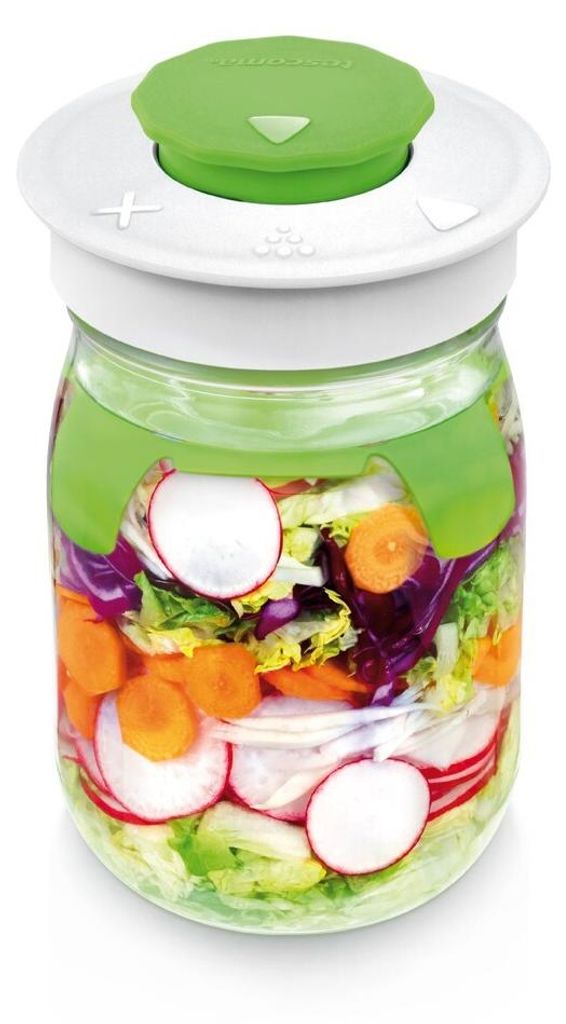 A glass jar filled with layered salad ingredients and a green lid.