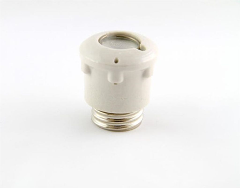 A white ceramic fuse holder with a silver threaded base is shown against a white background.