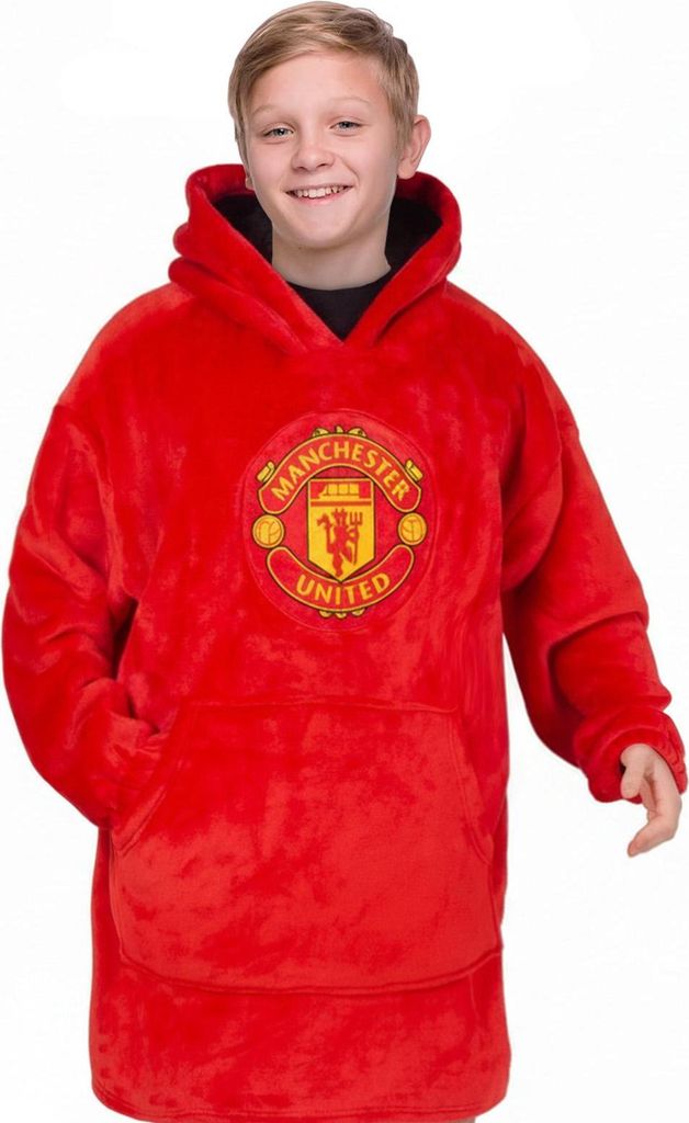 A young boy wearing a red Manchester United FC blanket hoodie.