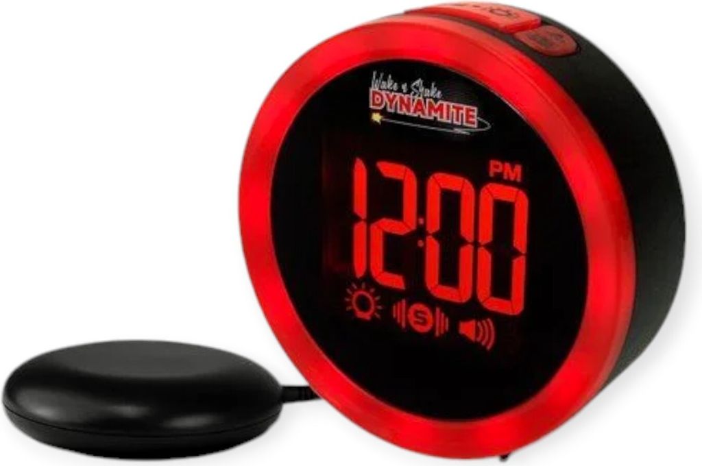 A close-up studio shot of a red and black digital alarm clock with a vibrating puck accessory.