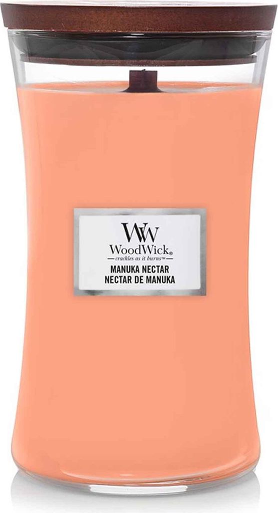 A WoodWick Manuka Nectar candle in a glass jar with a wooden lid.