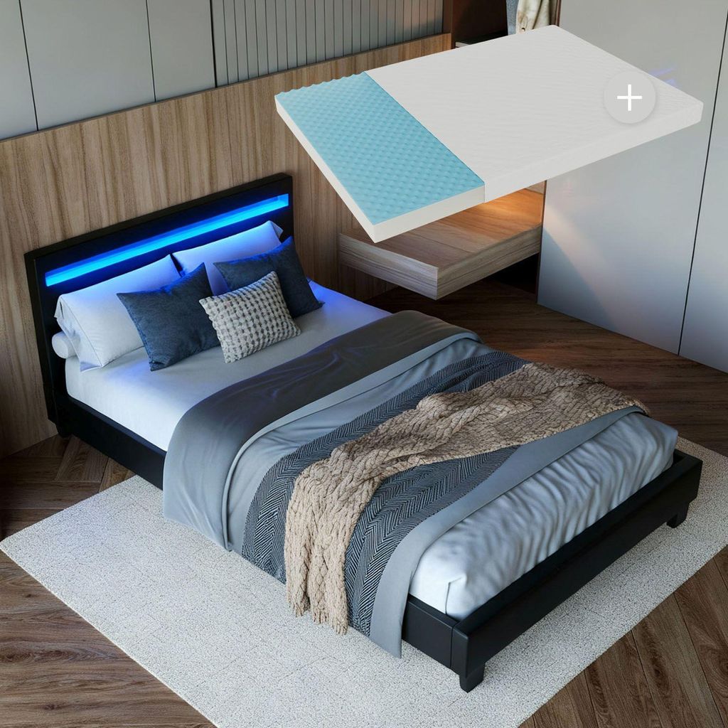 A bedroom scene featuring a bed with LED lighting and a mattress topper.