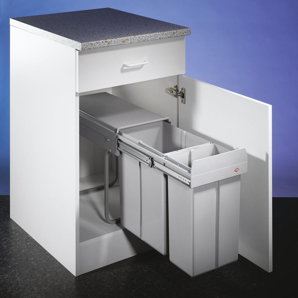A white kitchen cabinet with a pull-out trash bin system containing two gray bins.