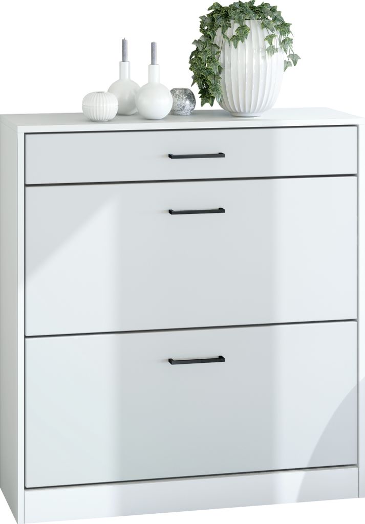 A white shoe cabinet with three drawers is shown against a white background. Decorative items, including a plant in a white pot, are placed on top of the cabinet.