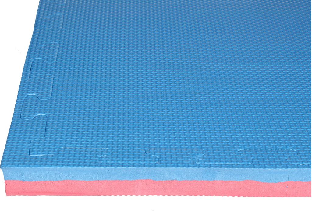 A close-up, side view of a blue and pink interlocking foam mat.