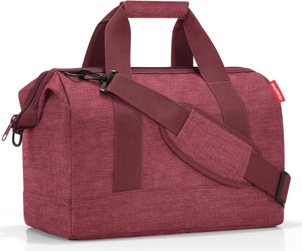A studio shot of a maroon duffel bag.