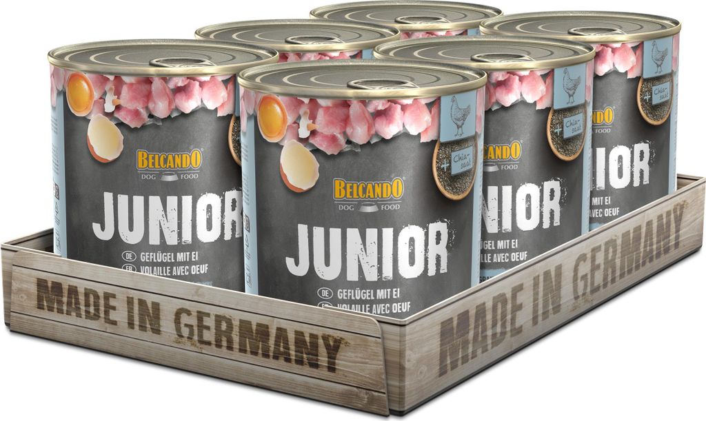 A six-pack of dog food cans in a wooden tray, with the text 'MADE IN GERMANY' prominently displayed.
