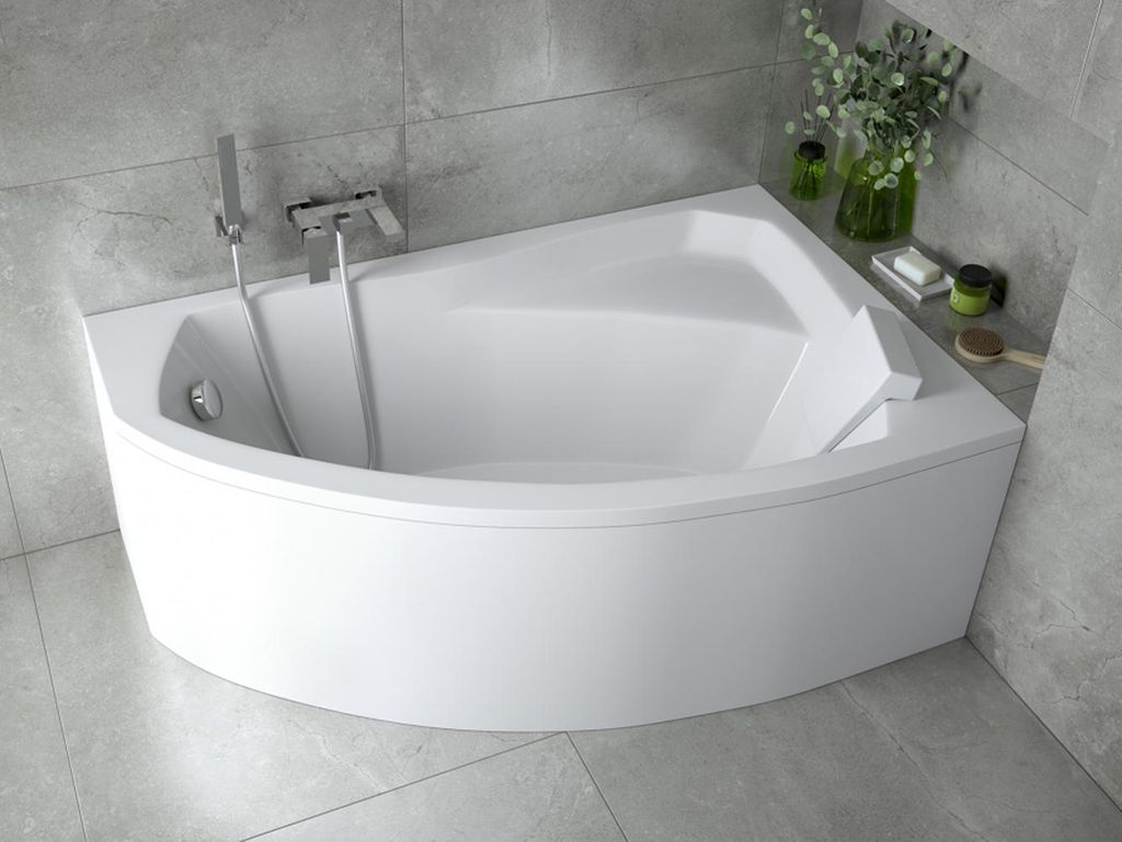 A white corner bathtub in a modern bathroom with gray tiled walls.