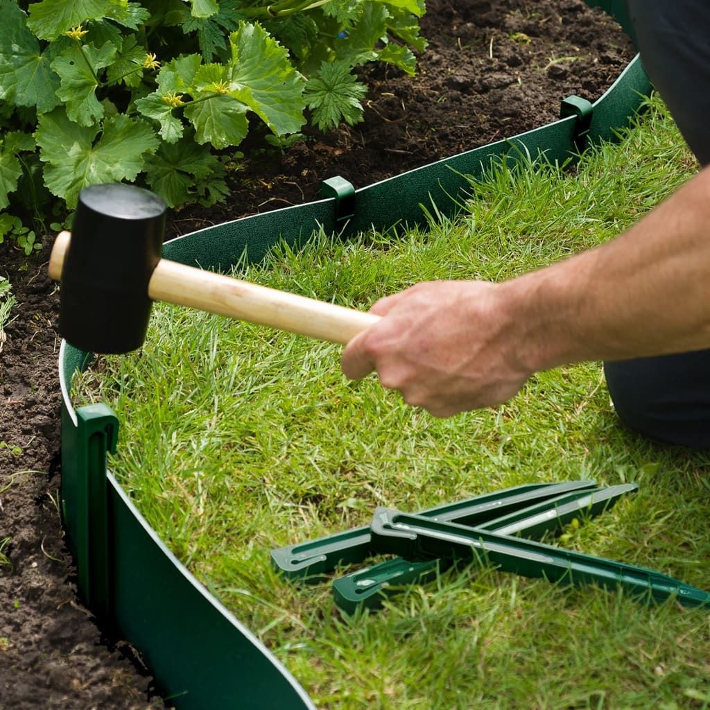 A person is installing garden edging with a mallet.
