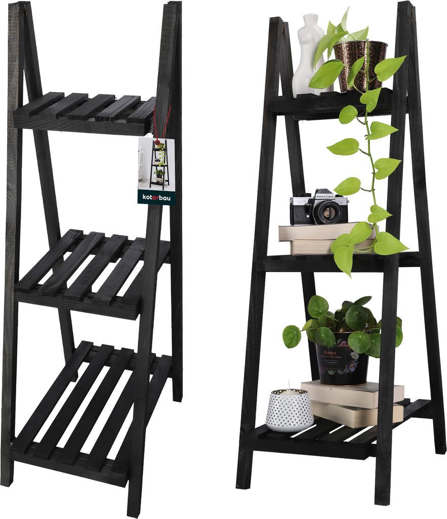 Two black wooden ladder shelves are shown side-by-side against a white background. The left shelf is empty except for a product tag. The right shelf displays several potted plants, books, and a vintage camera.