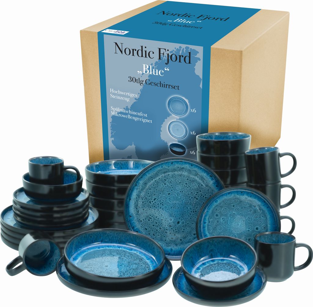 A set of blue and black ceramic dishes and mugs are displayed in front of a cardboard box with product information.