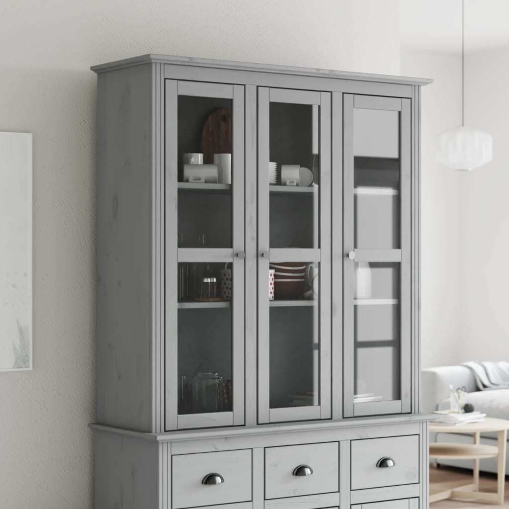 A gray wooden display cabinet with glass doors and drawers, shown in a room setting.