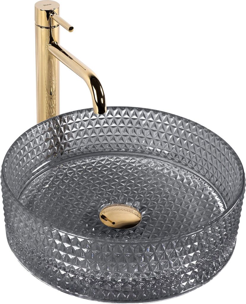 A close-up studio shot of a round glass vessel sink with a gold faucet.