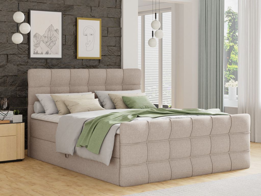 A bedroom scene with a beige boxspring bed as the main focus.