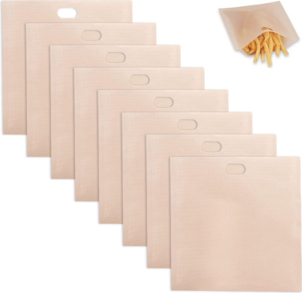 A stack of beige toaster bags with a small pile of french fries in one bag in the upper right corner.