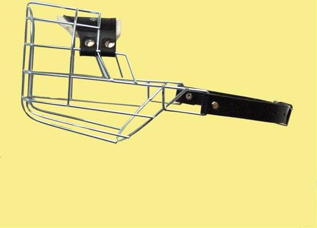 A wire dog muzzle on a yellow background.