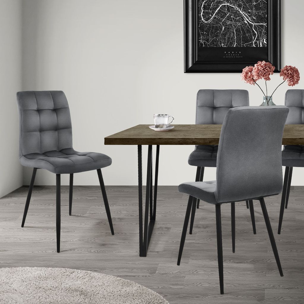 A dining room setting with a table and chairs.