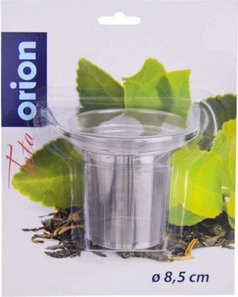 A tea strainer in its packaging, with green leaves and tea leaves as background.