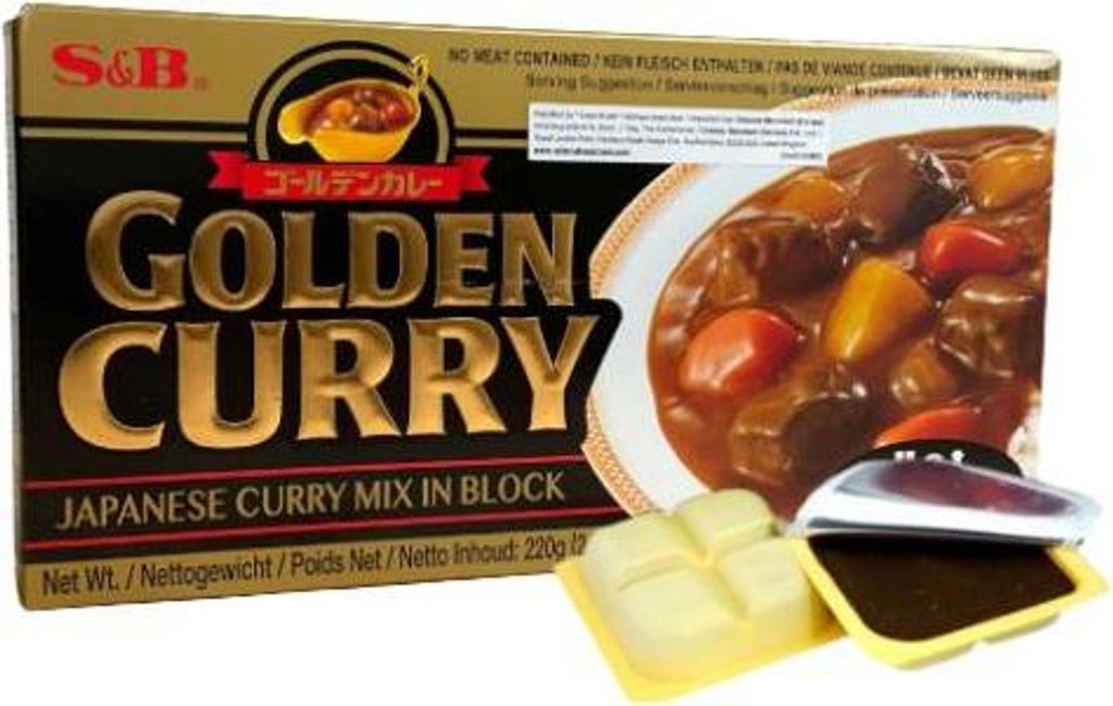 A box of S&B Golden Curry Japanese Curry Mix in Block, with two opened packets of the curry mix shown in the foreground.
