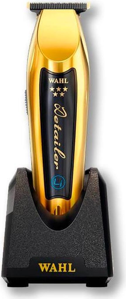 A gold Wahl Detailer cordless hair trimmer is shown standing upright in its black charging base.