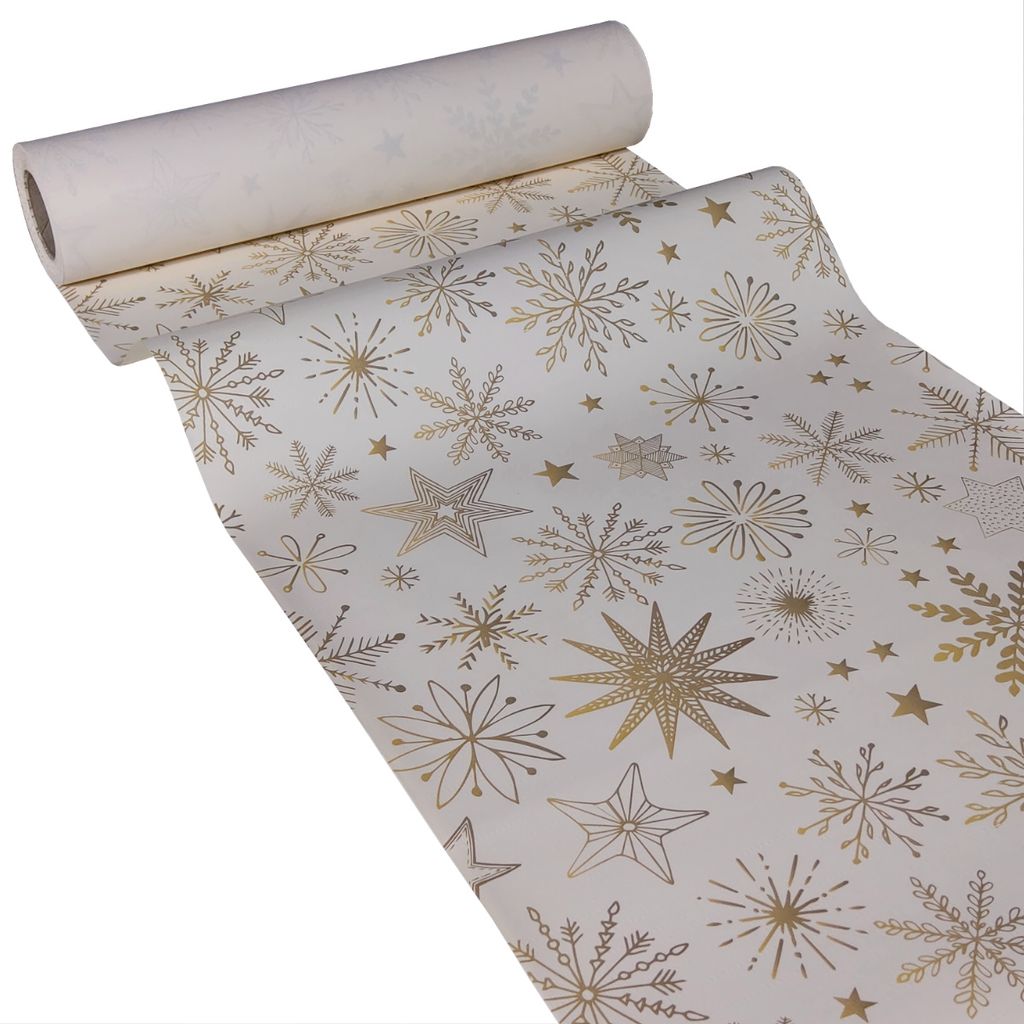 A roll of white paper table runner with gold snowflake and star patterns.