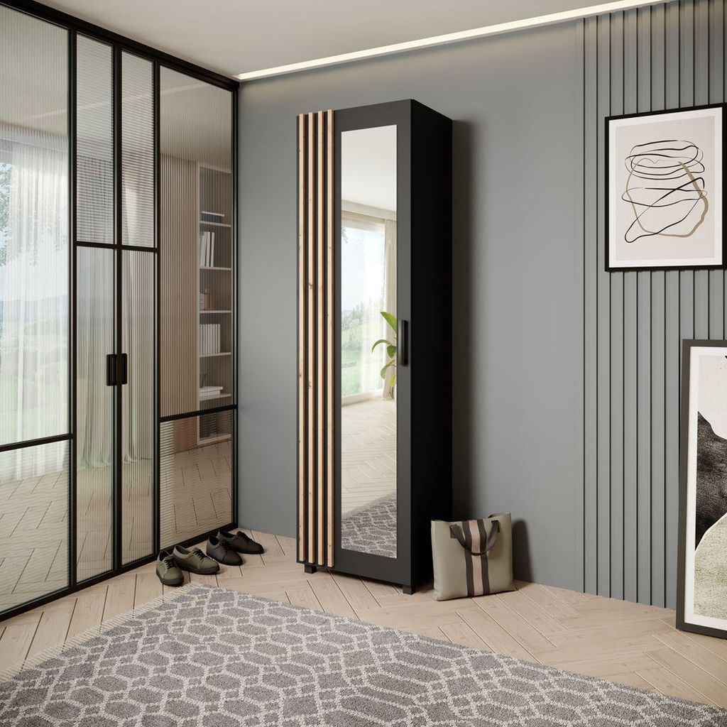 A modern entryway or dressing area with a wardrobe, glass doors, and a rug.