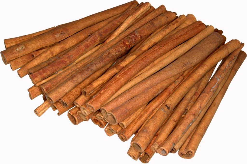 A pile of cinnamon sticks on a white background.