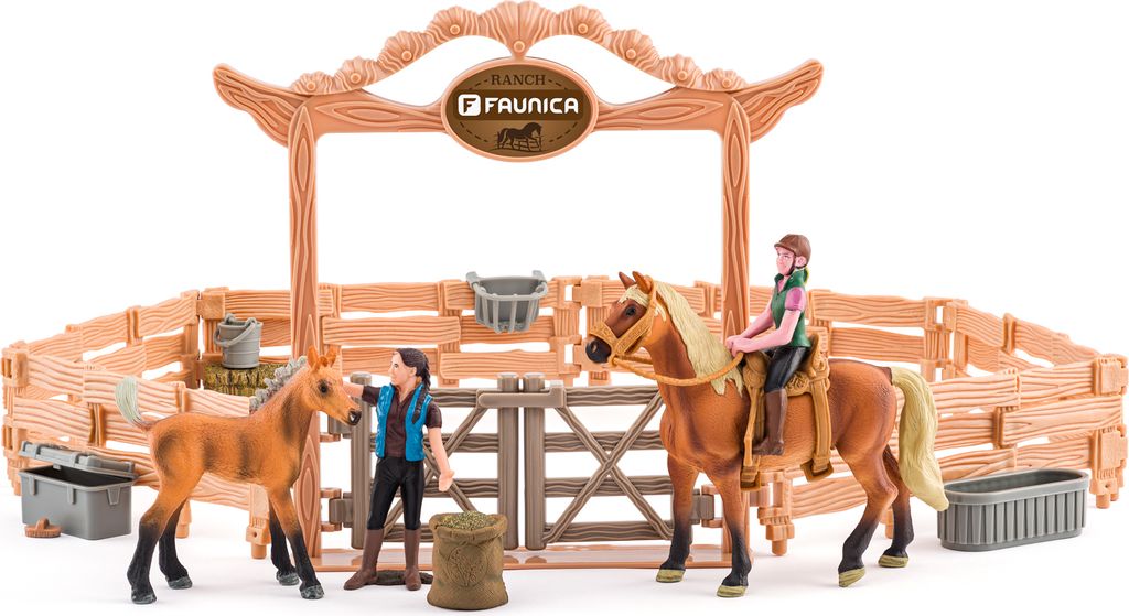 A toy ranch playset with horses and figures.