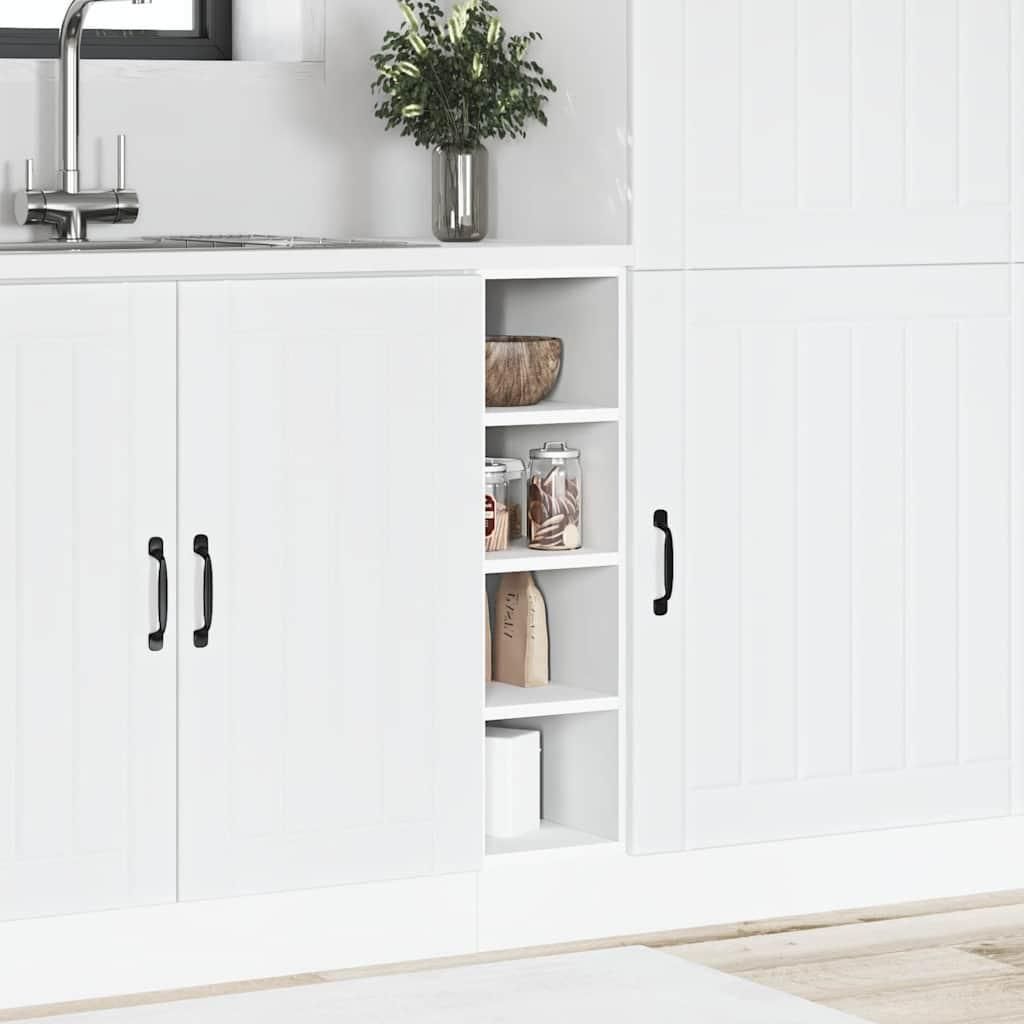 A white kitchen cabinet with a sink and a plant in the background.