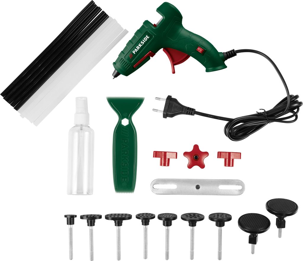 A flat lay of a car dent repair kit, including a glue gun, glue sticks, a spray bottle, a scraper, and various pulling tabs.