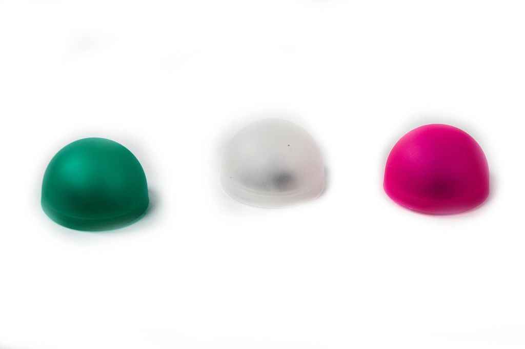 Three LED candle lights in green, white, and pink are arranged in a row against a white background.