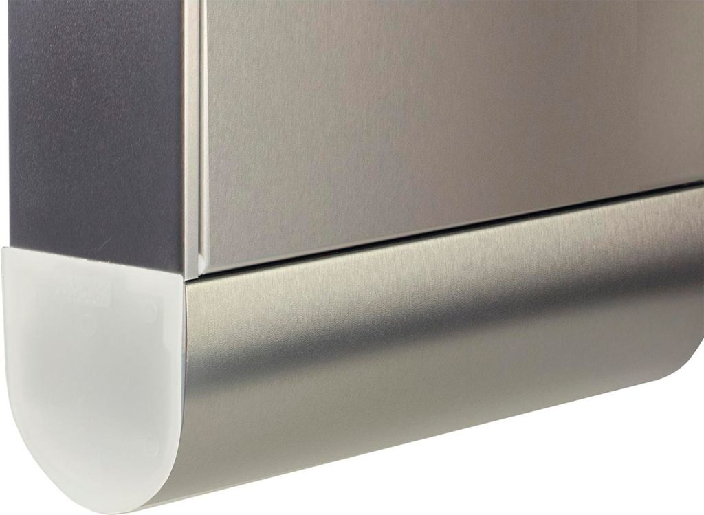 A close-up view of the corner of a metallic object with a white protective cap.