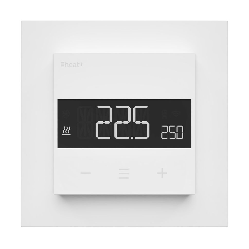 A white thermostat mounted on a white wall plate.