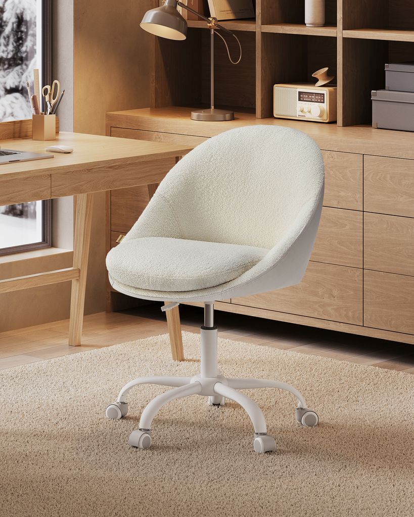 A close-up of a cream-colored office chair with a fluffy texture, placed on a beige carpet in front of a wooden desk and cabinet.