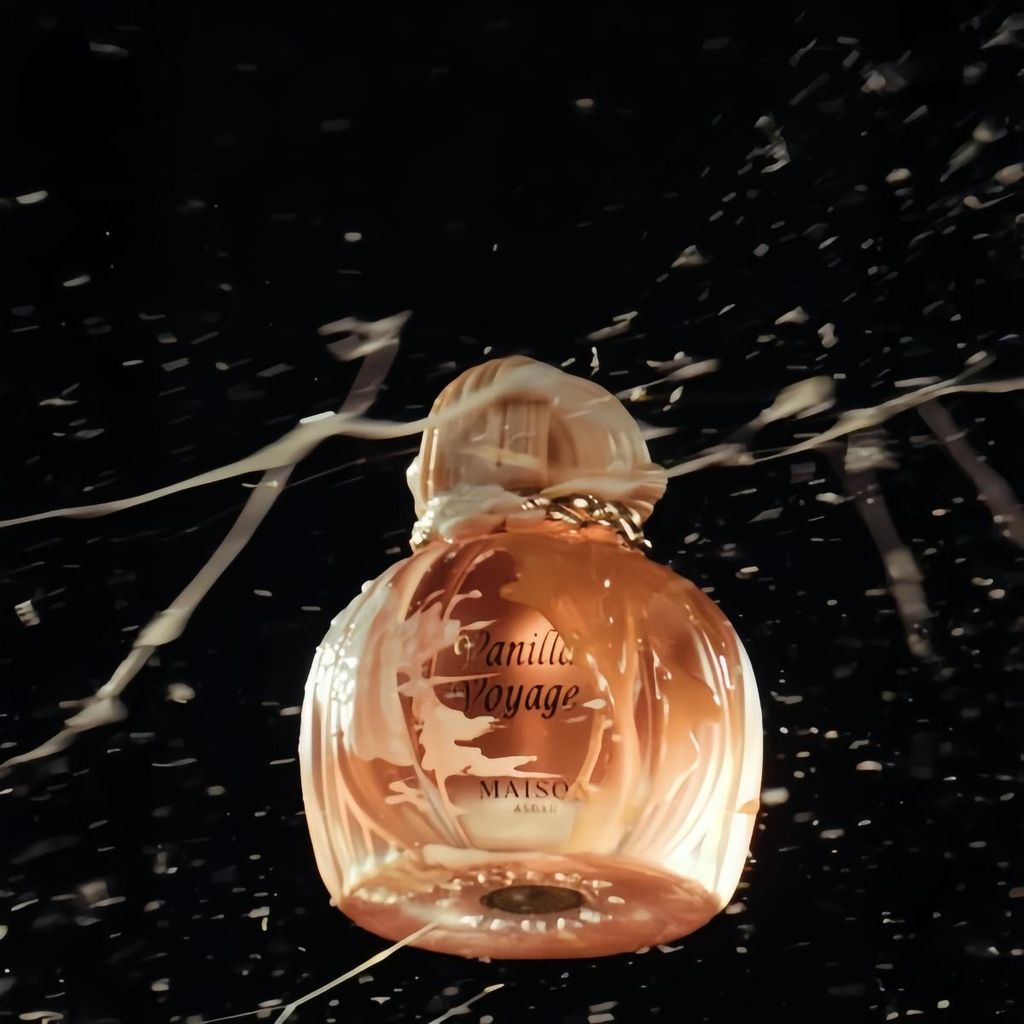 A perfume bottle with liquid splashing around it.