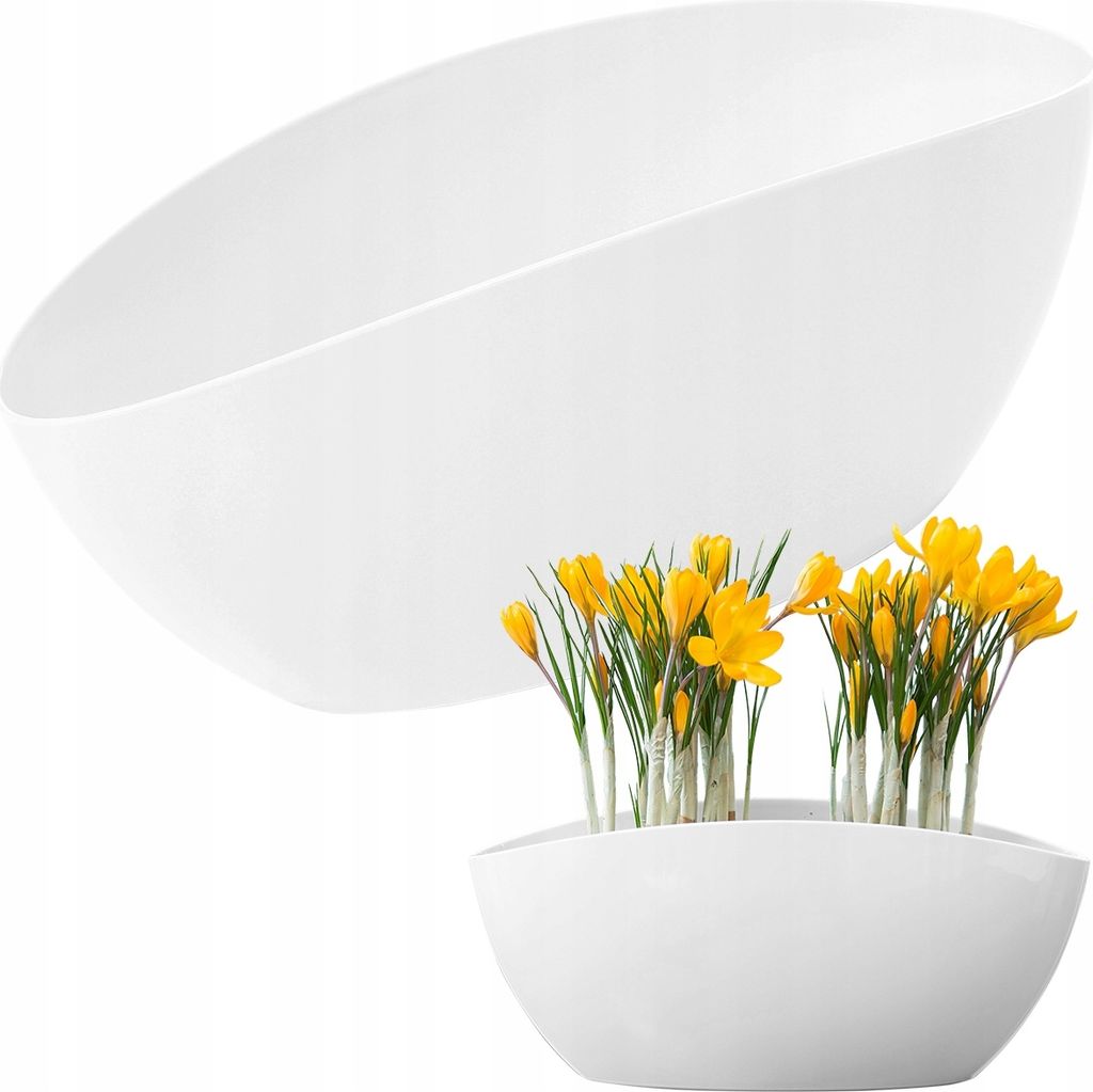 A white planter with yellow crocuses in the foreground and a larger, empty white planter in the background.