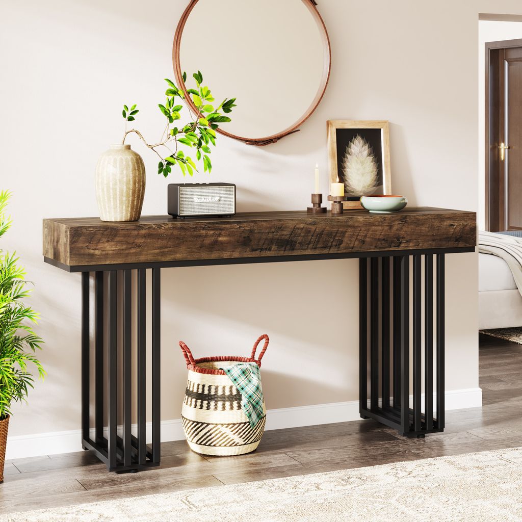 A console table with decorative items on top and a basket underneath, placed in a hallway or entryway.