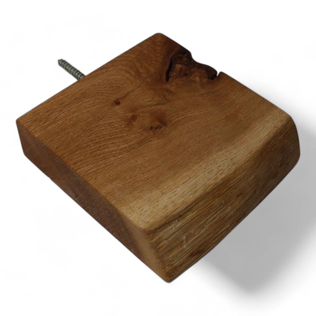 A single wooden shelf with a natural edge is shown against a white background. A screw is partially visible on the left side.